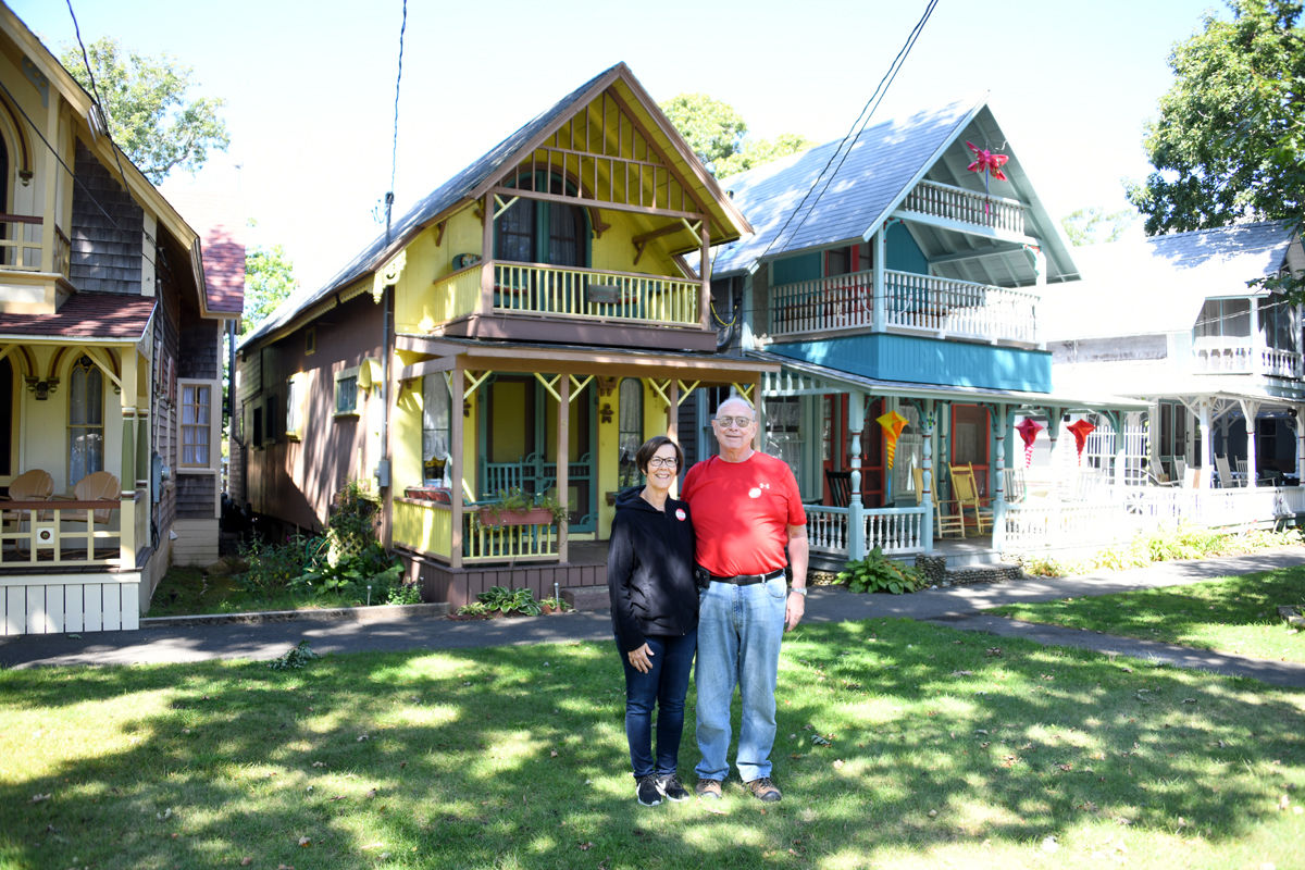 218 Pat and Terry Willis pose with the decorative Gingerbread Houses..jpg